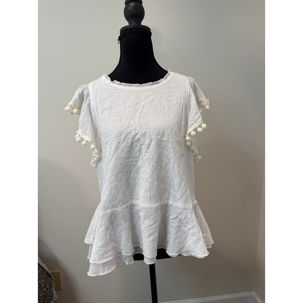 Cupio White loose fitting top with pompoms on cap sleeves